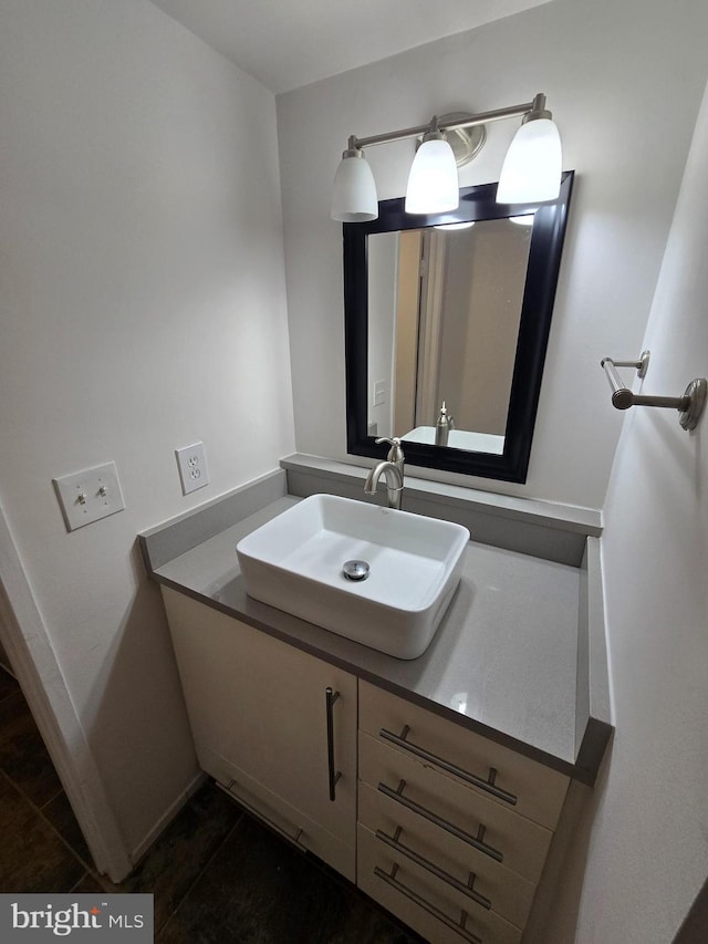 bathroom featuring baseboards and vanity