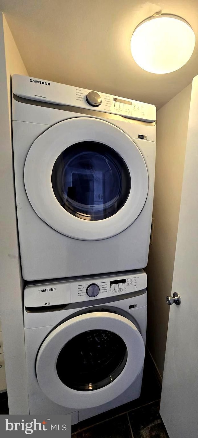 clothes washing area with laundry area and stacked washer / dryer