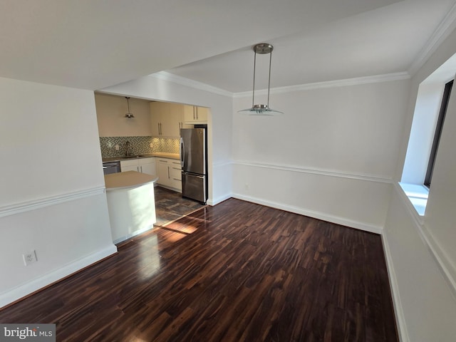 interior space featuring crown molding, baseboards, and dark wood-style flooring