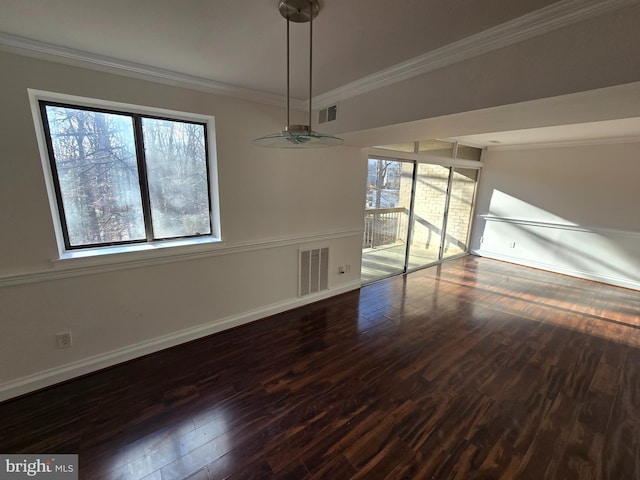 unfurnished dining area with dark wood-style floors, baseboards, visible vents, and crown molding