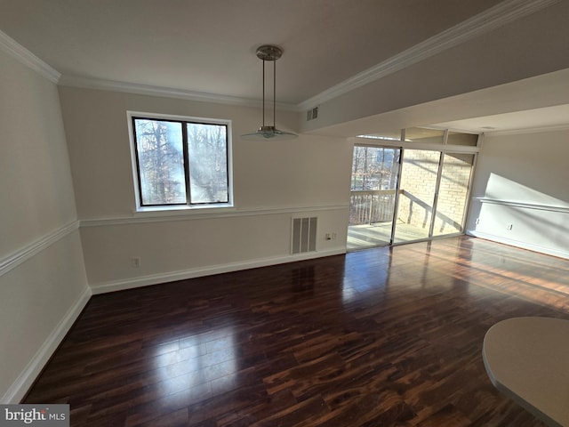 unfurnished dining area with ornamental molding, visible vents, baseboards, and wood finished floors