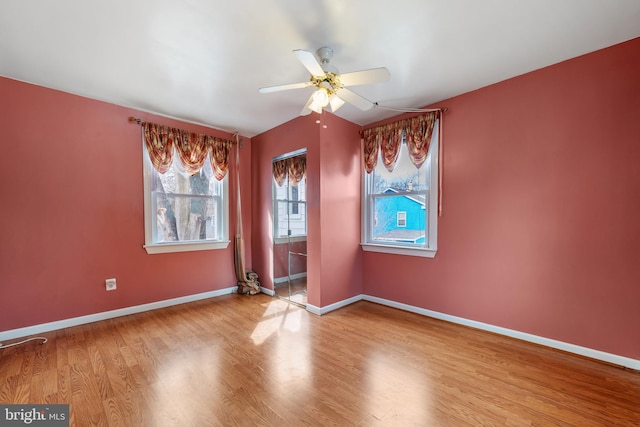 unfurnished room featuring ceiling fan, baseboards, and wood finished floors