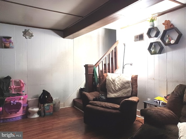 living area with stairs, visible vents, and dark wood finished floors