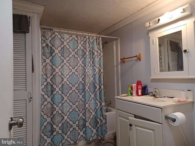 full bathroom with a textured ceiling, ornamental molding, shower / bath combination with curtain, and vanity