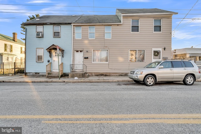 multi unit property with entry steps, cooling unit, and fence