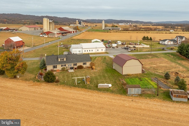 birds eye view of property featuring a mountain view and a rural view