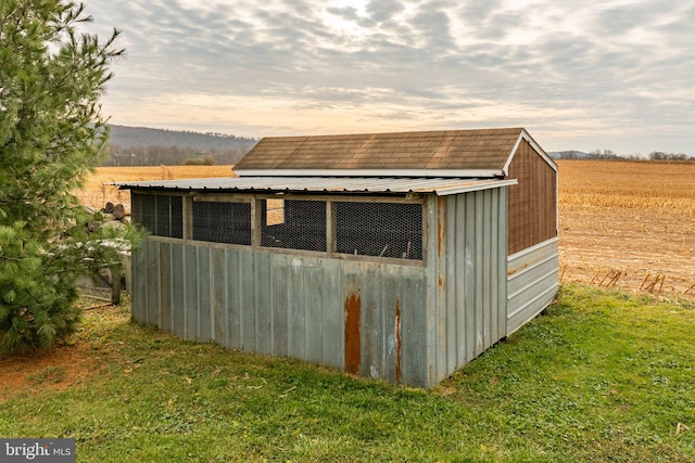 outdoor structure at dusk with an outbuilding