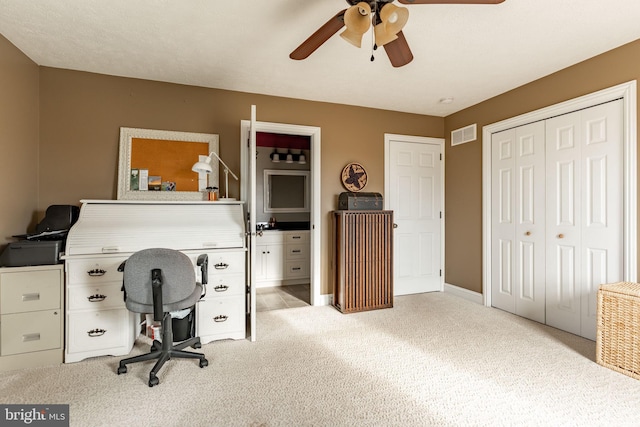 office with carpet, visible vents, ceiling fan, and baseboards