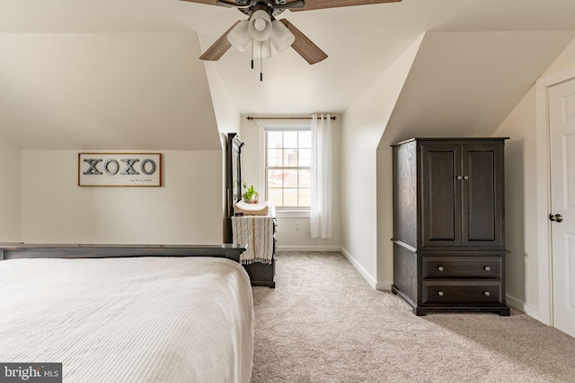 bedroom with lofted ceiling, light carpet, ceiling fan, and baseboards