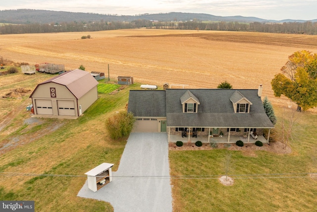 bird's eye view featuring a rural view and a mountain view