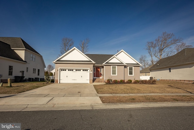 view of front of house featuring concrete driveway, an attached garage, and a shingled roof