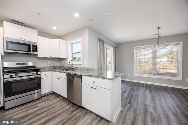 kitchen featuring white cabinets, visible vents, appliances with stainless steel finishes, and a sink