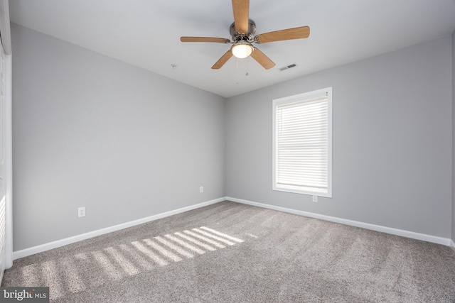 empty room with visible vents, baseboards, ceiling fan, and carpet flooring