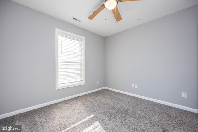 unfurnished room featuring visible vents, baseboards, carpet, and a ceiling fan