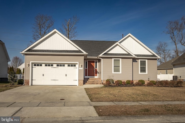 view of front facade featuring concrete driveway, a garage, and a shingled roof