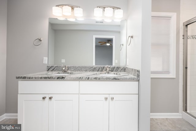 bathroom with a sink, visible vents, ceiling fan, and a tile shower