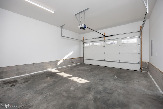 garage featuring electric panel and a garage door opener