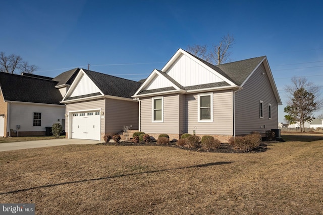 view of front of home with board and batten siding, a shingled roof, a front lawn, a garage, and driveway