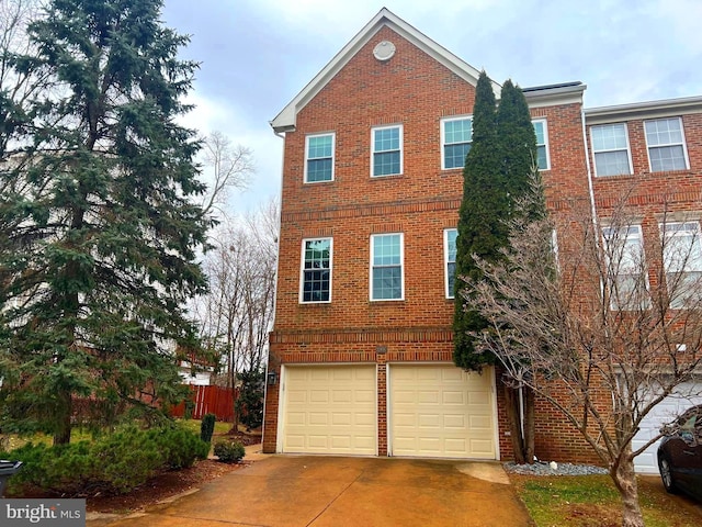 view of front of property featuring an attached garage, fence, concrete driveway, and brick siding