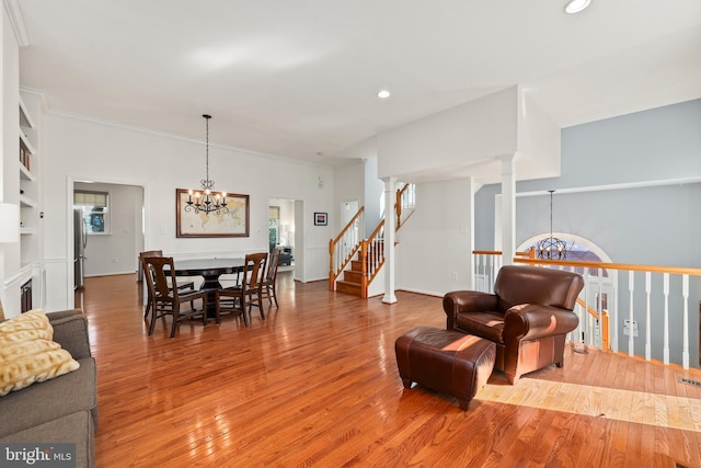 living area featuring ornate columns, a chandelier, hardwood / wood-style floors, and recessed lighting