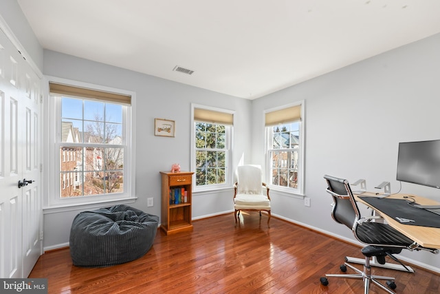 office area featuring hardwood / wood-style flooring, visible vents, and baseboards