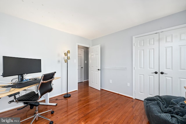 office space featuring baseboards and wood finished floors