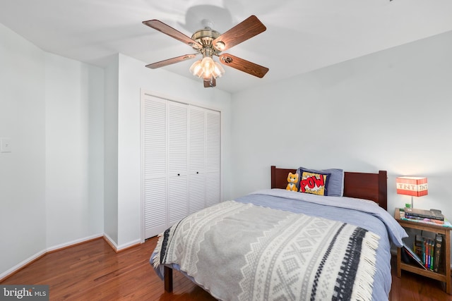 bedroom featuring a closet, wood finished floors, a ceiling fan, and baseboards