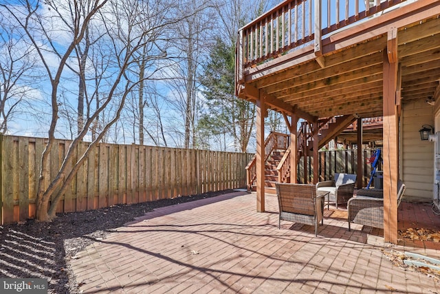 view of patio with a fenced backyard, stairs, and a wooden deck