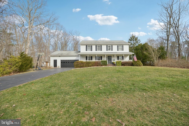 view of front facade featuring driveway, a porch, a front lawn, and an attached garage