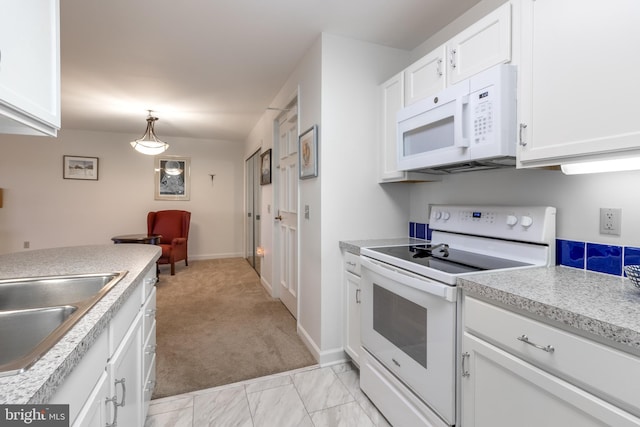 305 Village Heights Dr Unit 325, State College, PA 16801 - kitchen with white appliances, baseboards, light countertops, white cabinets, and light colored carpet