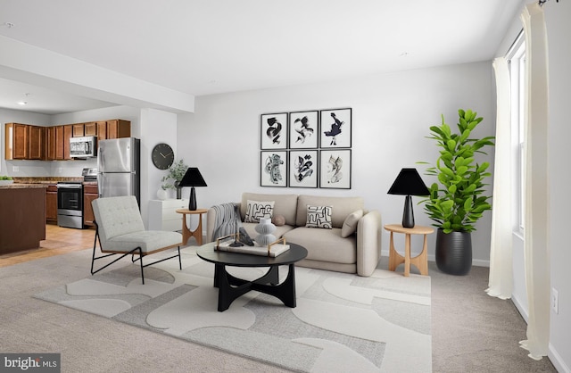 living room featuring light colored carpet and baseboards