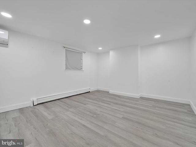 finished below grade area featuring a baseboard radiator, baseboards, wood finished floors, and recessed lighting