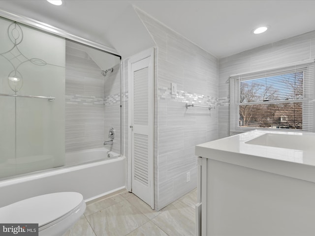 full bath with washtub / shower combination, toilet, and tile walls