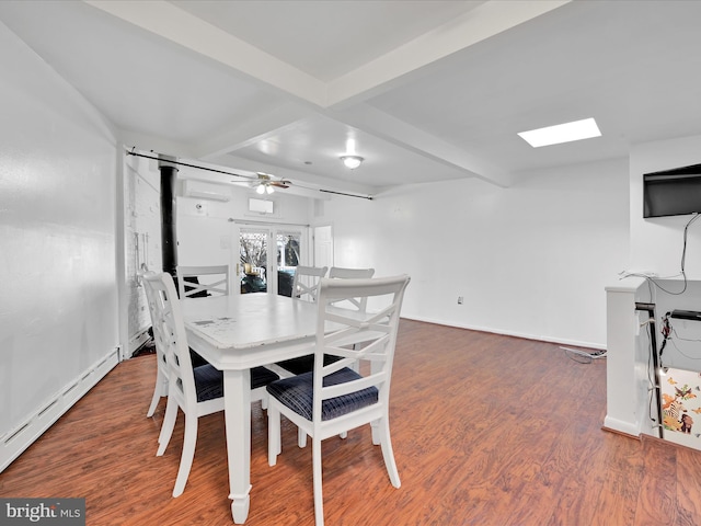 dining space with a baseboard heating unit, beam ceiling, and wood finished floors