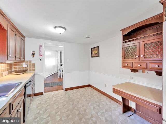 kitchen featuring dishwashing machine, light floors, tasteful backsplash, light countertops, and baseboards