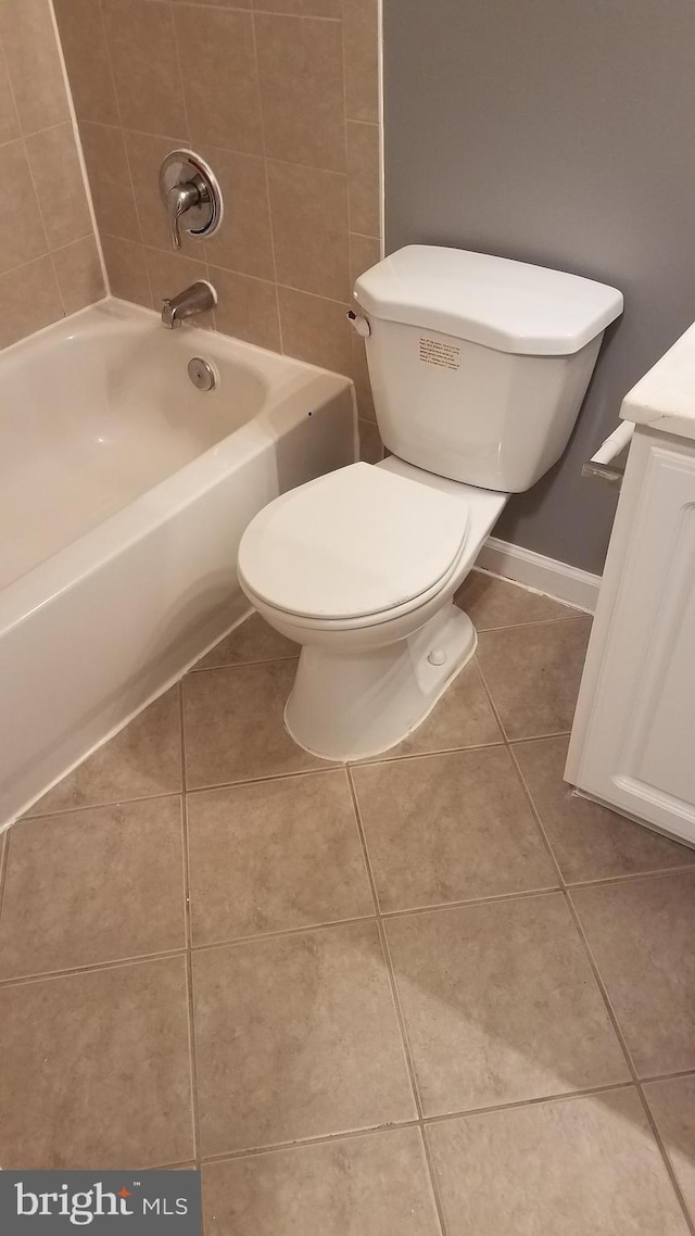 bathroom featuring baseboards, vanity, toilet, and tile patterned floors