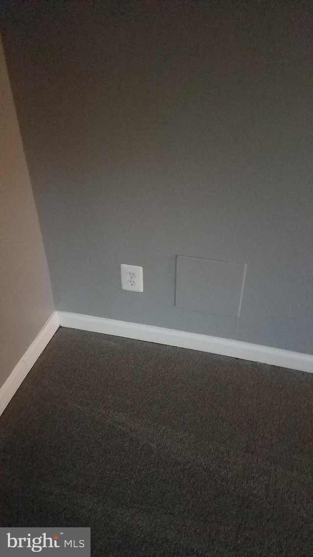 carpeted empty room with baseboards