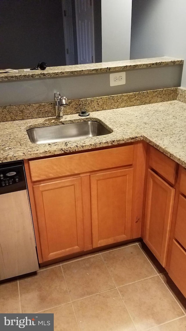 bathroom featuring tile patterned flooring and a sink