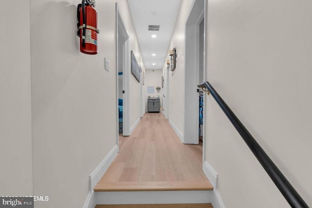 corridor featuring visible vents, recessed lighting, light wood-style flooring, and baseboards