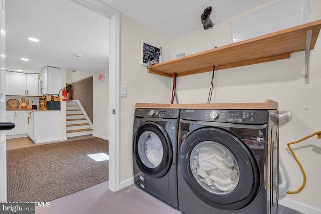 washroom with laundry area, washing machine and dryer, baseboards, and recessed lighting