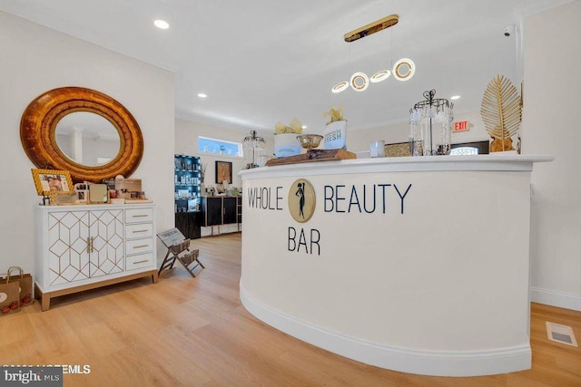 interior space featuring baseboards, visible vents, wood finished floors, and recessed lighting