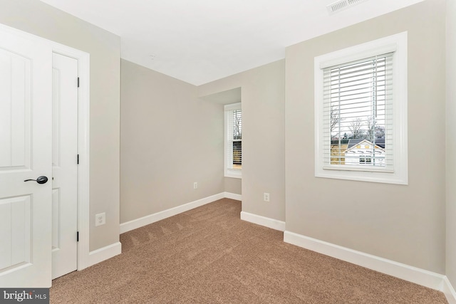 unfurnished bedroom featuring carpet, visible vents, and baseboards