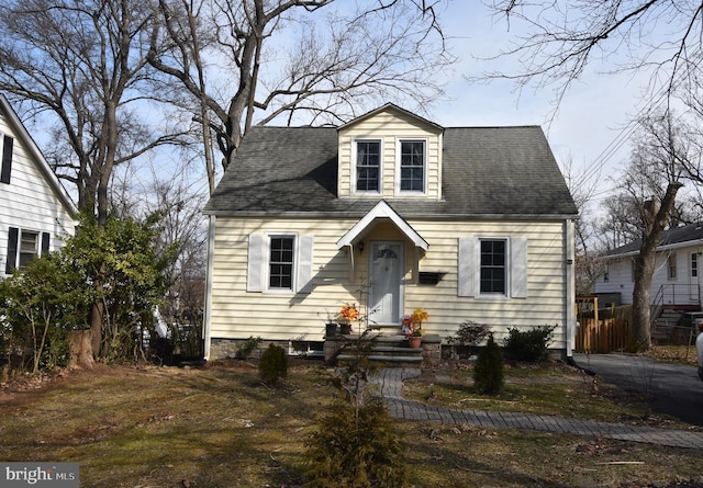 cape cod house with entry steps and roof with shingles