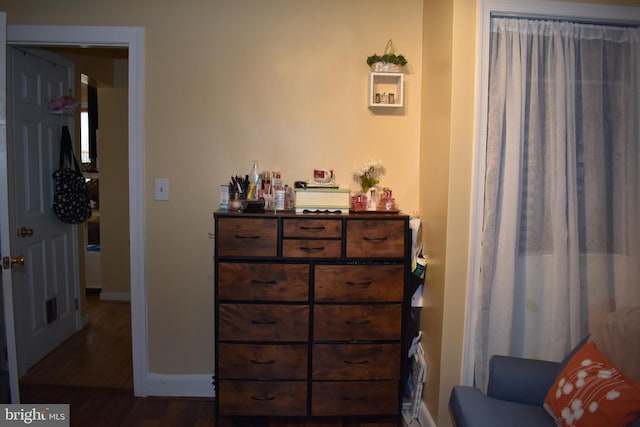 bedroom featuring dark wood-style flooring and baseboards