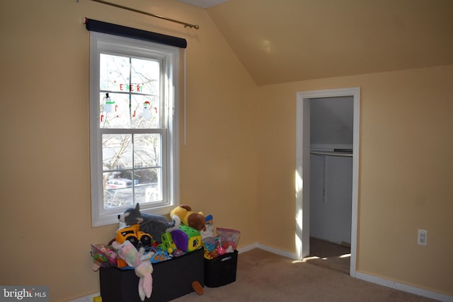 playroom with carpet floors, vaulted ceiling, and baseboards