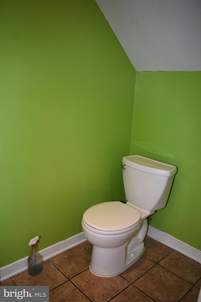 half bathroom featuring toilet, tile patterned flooring, and baseboards