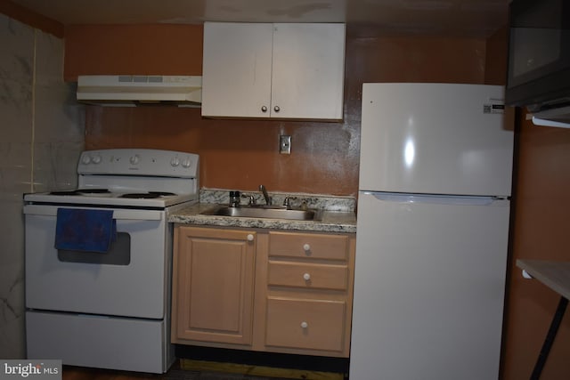 kitchen featuring light countertops, white appliances, a sink, and under cabinet range hood