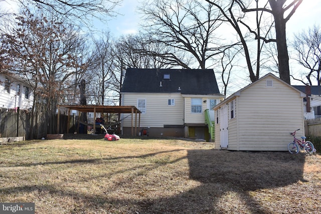 back of property featuring a lawn and an outdoor structure