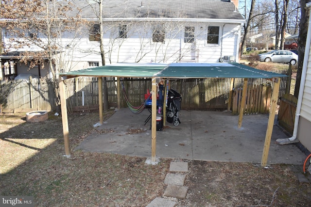 exterior space with a carport and fence