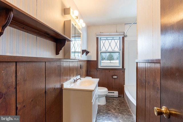 bathroom with a washtub, a wainscoted wall, toilet, a baseboard heating unit, and vanity